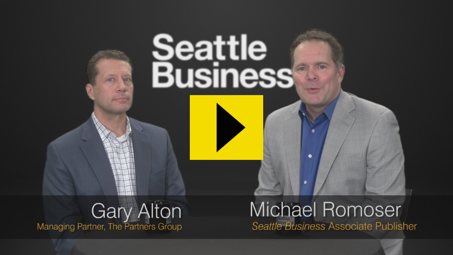 Screenshot of Gary and Michael Romoser from Seattle Business with Play Button in Yellow
